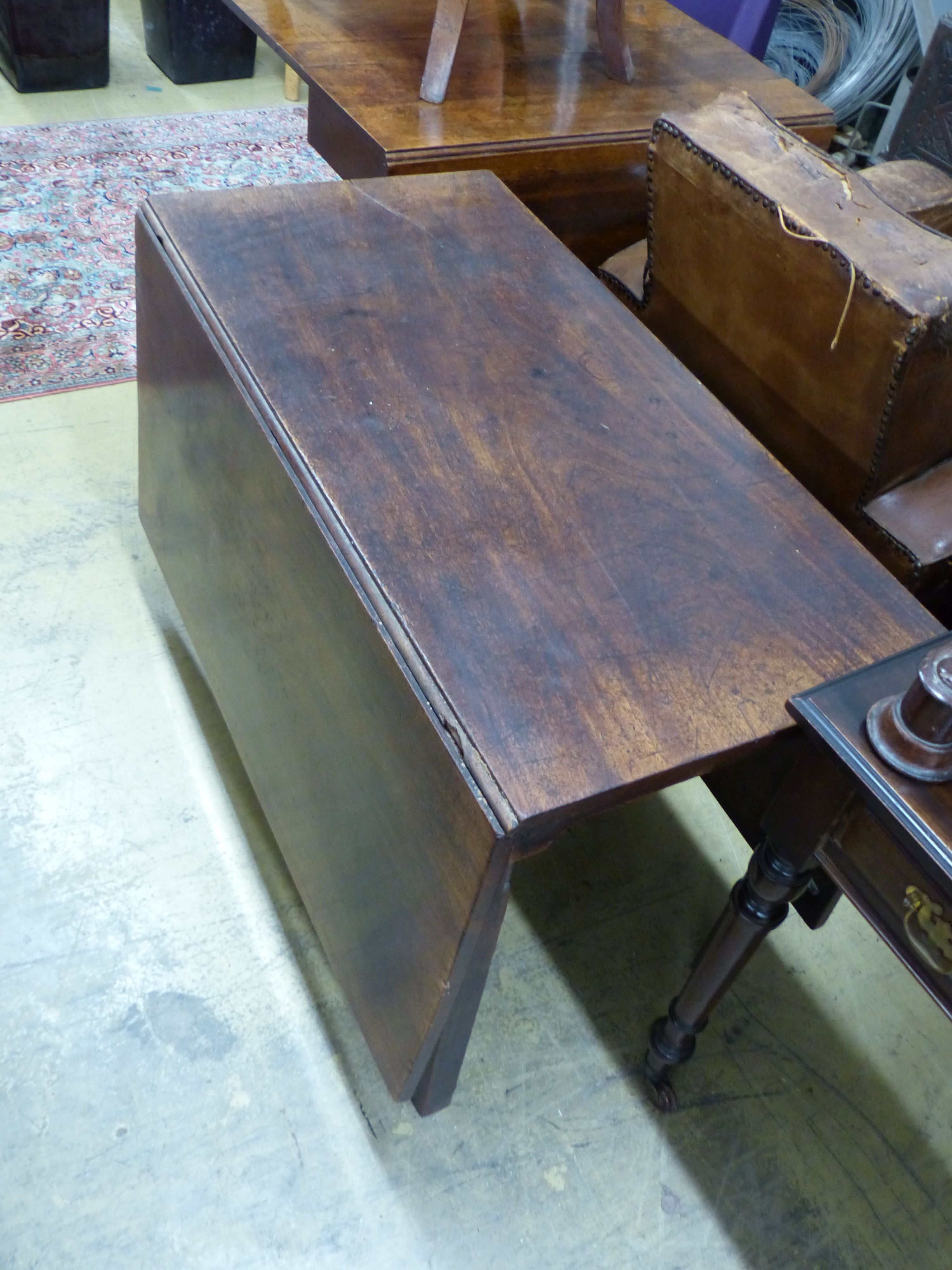 A George III mahogany drop leaf dining table, length 104cm